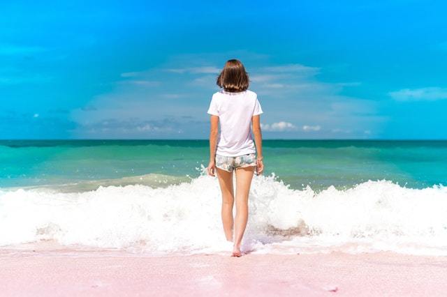 girl walking into waves