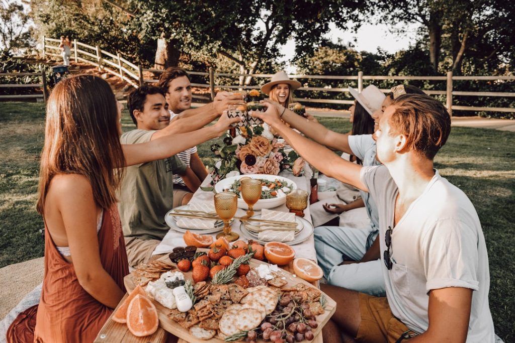 Photo by Nicole Herrero people sitting on chair eating food during daytime